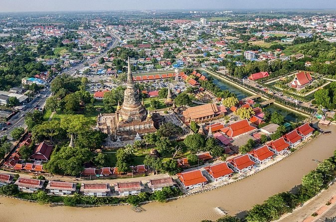 A riverside monastery and the modern town seen from the air over Ayutthaya