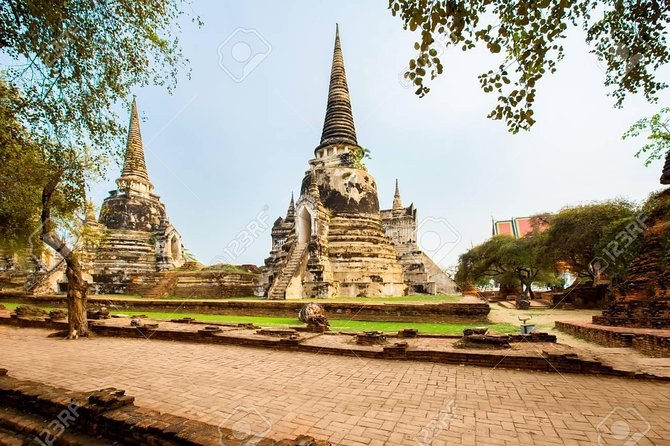The three restored chedi of Wat Phra Si Sanphet standing in a row above the lawn